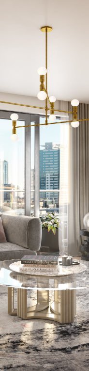 Modern living room with large windows overlooking a city, featuring a plush sofa, stylish round coffee table, geometric rug, and an elegant chandelier.