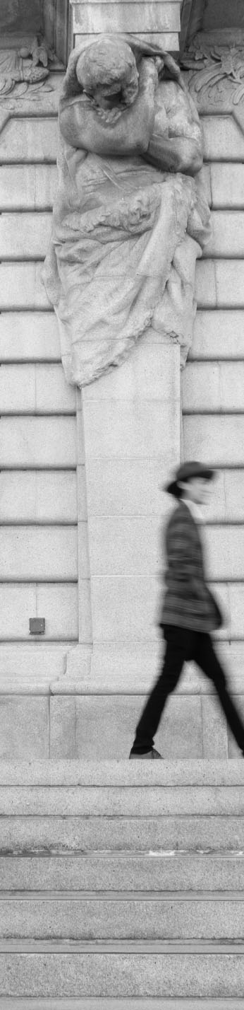 a black-and-white photo of a person walking above some steps